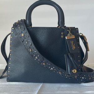 Coach Rogue 25 dark navy with prairie rivets and novelty strap